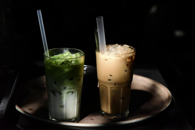 Row of colourful bubble tea cups with boba pearls on a bright background, Singapore