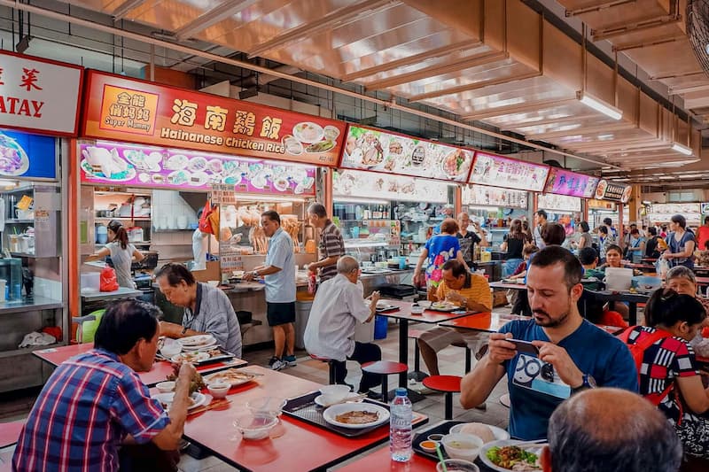 A spread of Singapore hawker food including yong tau foo, sliced fish soup and steamed chicken rice — good choices for diabetics